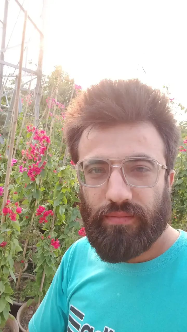 Arshad in garden flowers teal shirt